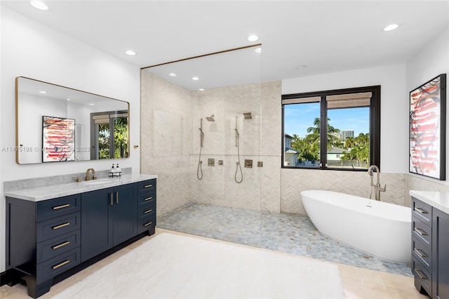 bathroom featuring tile walls, recessed lighting, a soaking tub, vanity, and a walk in shower