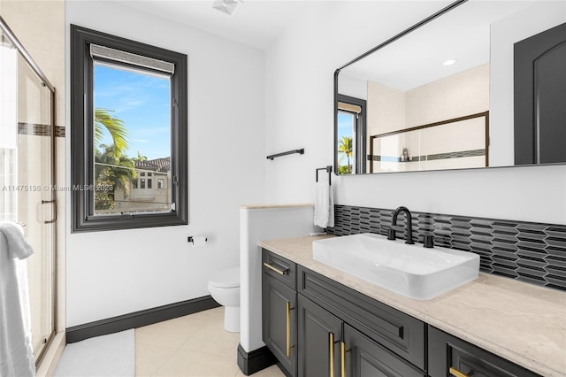 full bath with visible vents, toilet, vanity, baseboards, and tile patterned floors