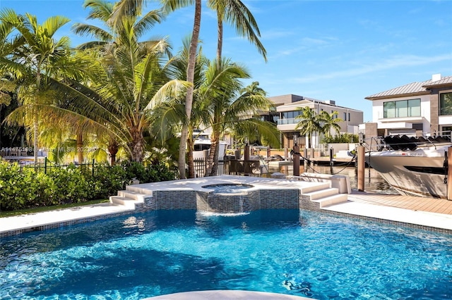 pool featuring fence and an in ground hot tub