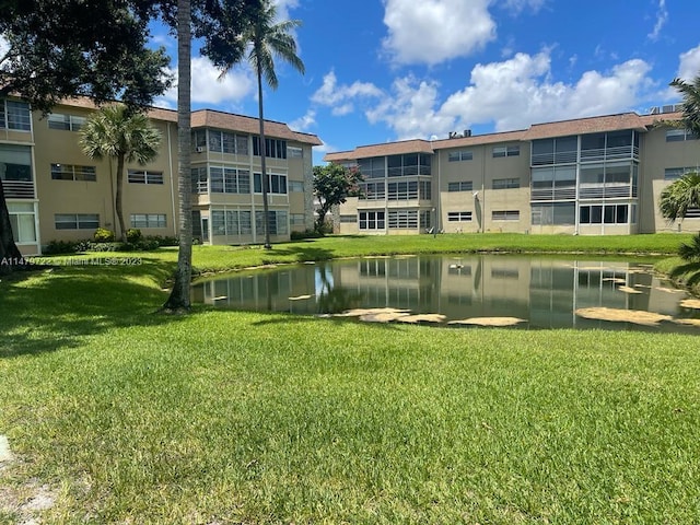 surrounding community featuring a yard and a water view