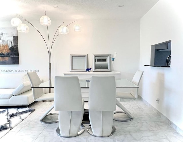 dining area featuring a textured ceiling