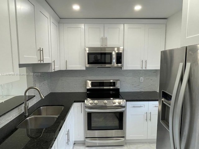 kitchen with sink, white cabinets, and appliances with stainless steel finishes