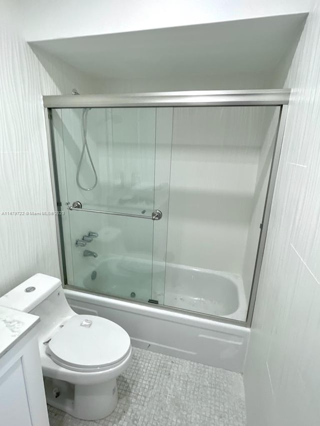 full bathroom featuring tile patterned flooring, vanity, toilet, and enclosed tub / shower combo