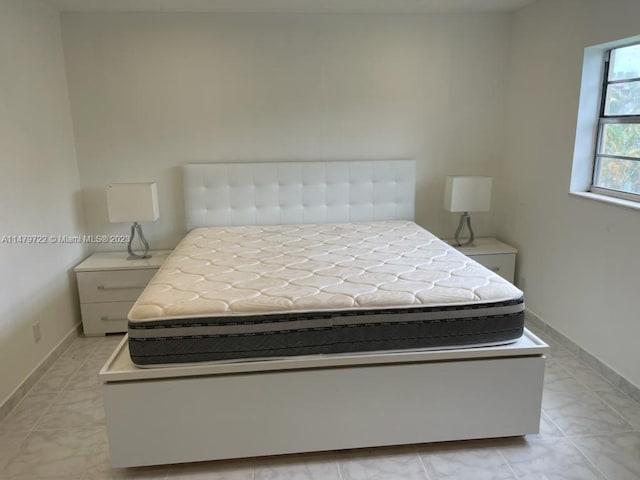 bedroom with light tile patterned flooring