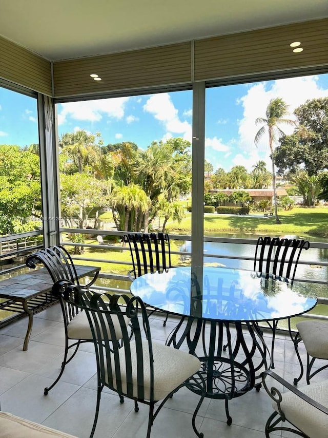 sunroom / solarium with a water view