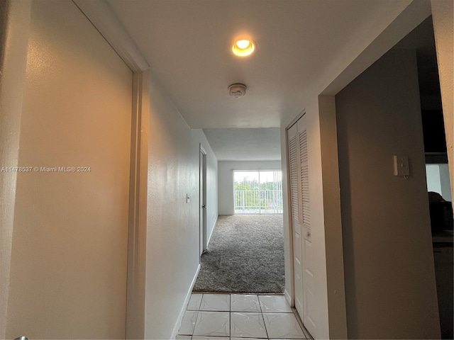 hallway featuring light colored carpet