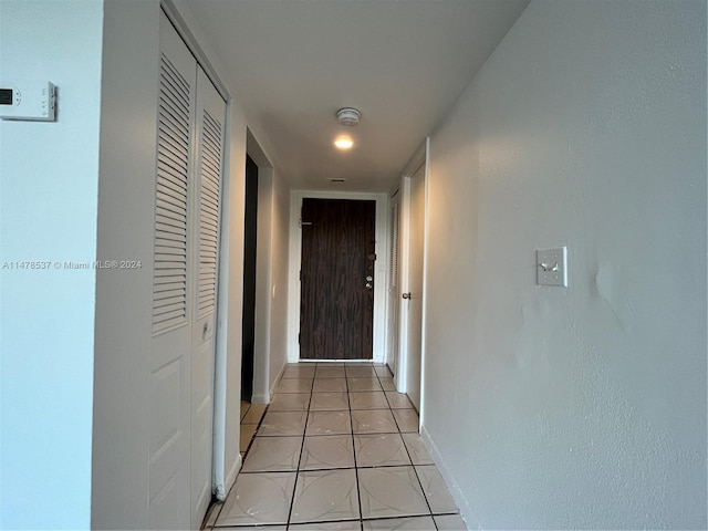 hallway featuring light tile floors