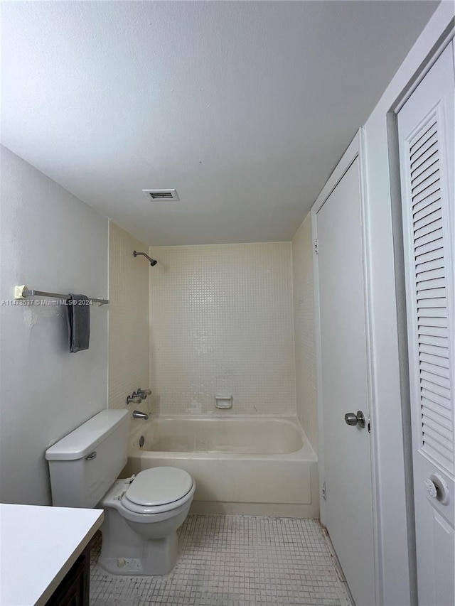 full bathroom featuring tiled shower / bath combo, toilet, tile flooring, and vanity