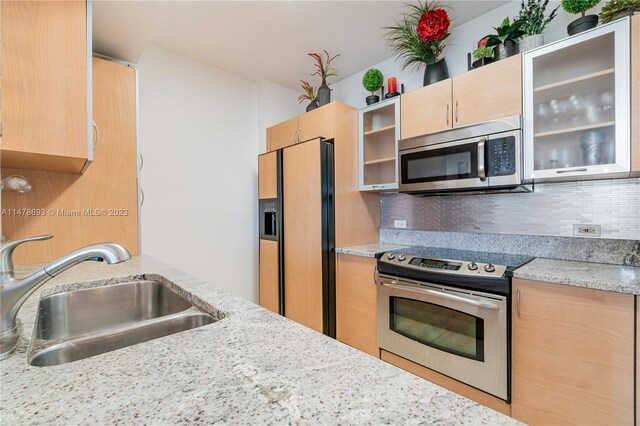 2775 NE 187th St Unit 516, Aventura, FL 33180 - kitchen with appliances with stainless steel finishes, light brown cabinets, decorative backsplash, and a sink