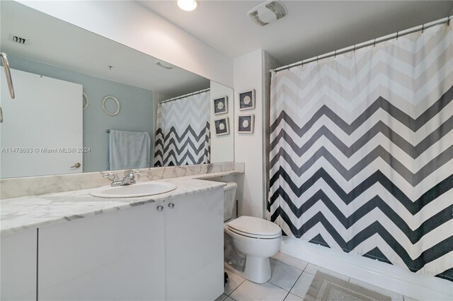 2775 NE 187th St Unit 516, Aventura, FL 33180 - bathroom featuring curtained shower, vanity, toilet, and tile patterned flooring