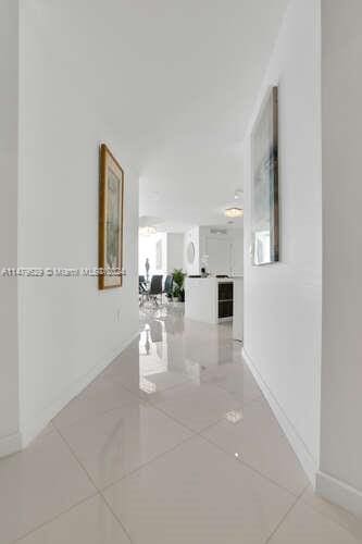 hall featuring light tile flooring