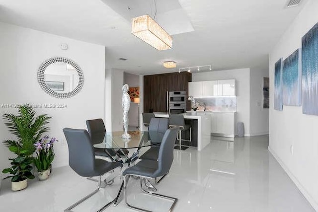 tiled dining space with track lighting