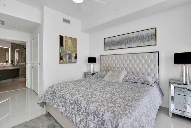 tiled bedroom featuring ceiling fan and ensuite bathroom