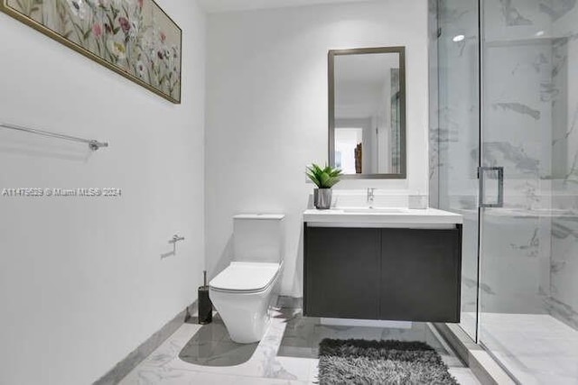 bathroom with tile flooring, a shower with shower door, vanity with extensive cabinet space, and toilet