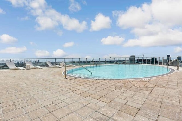 view of swimming pool with a patio area