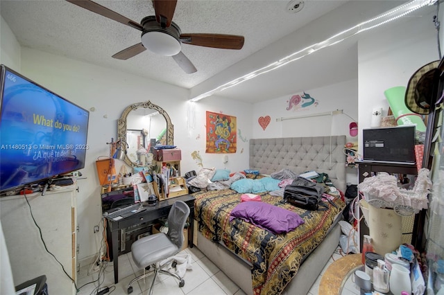 tiled bedroom featuring ceiling fan and a textured ceiling