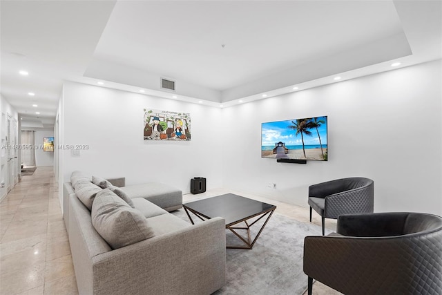 tiled living room with a tray ceiling