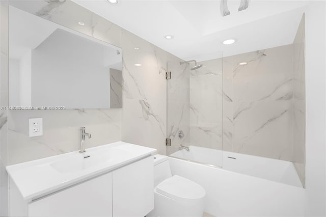 full bathroom featuring tile walls, tiled shower / bath combo, toilet, and vanity