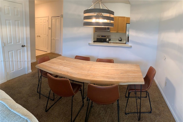 dining space featuring light colored carpet and a notable chandelier