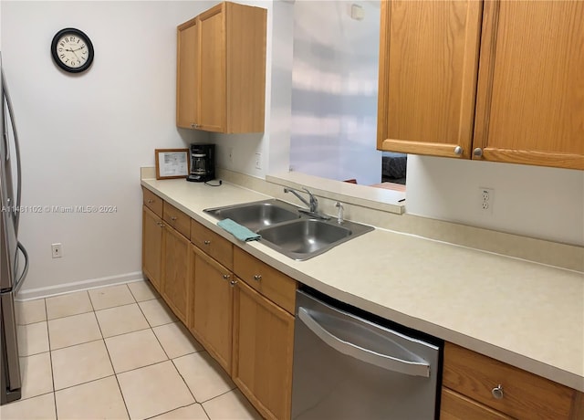 kitchen with stainless steel dishwasher, light tile patterned flooring, and sink