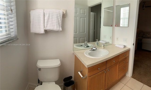 bathroom with tile patterned flooring, vanity, and toilet