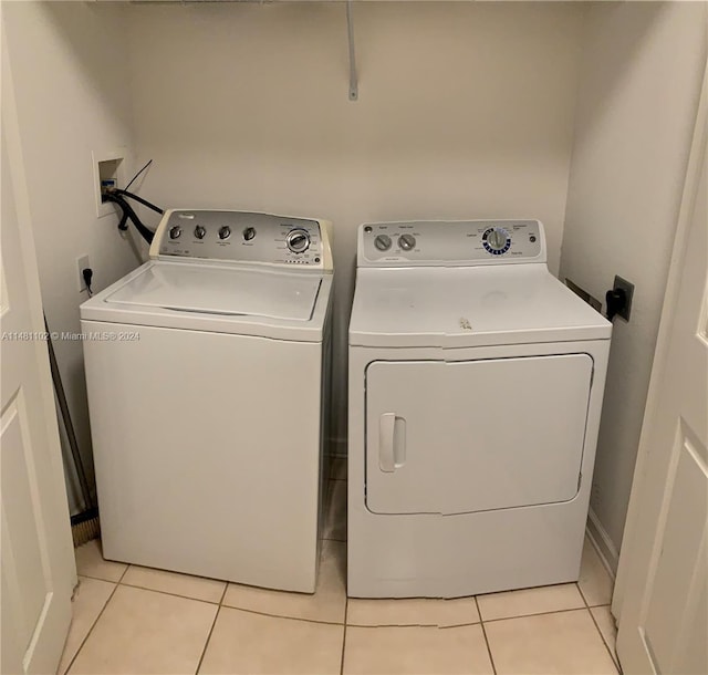 laundry room with light tile patterned floors and washer and dryer