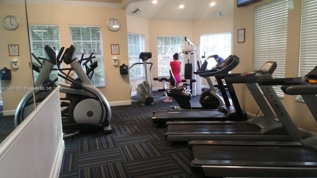 exercise room with lofted ceiling and crown molding