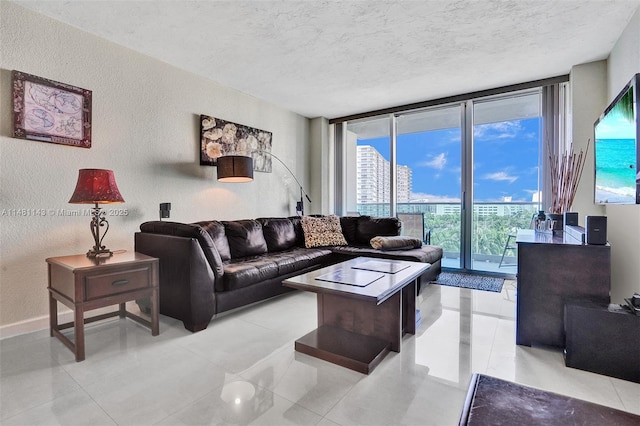 living room with expansive windows and a textured ceiling