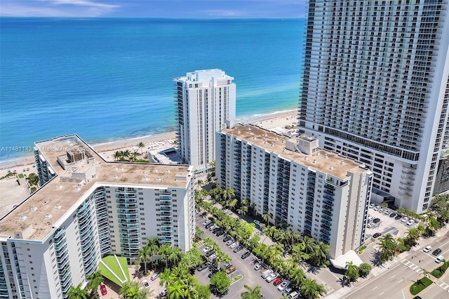 birds eye view of property with a view of the beach and a water view