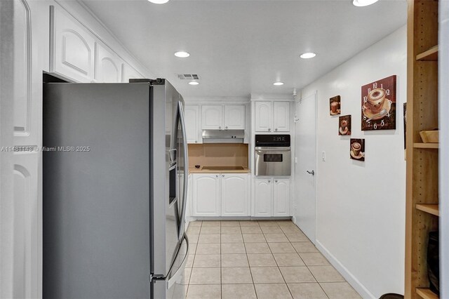 kitchen featuring light tile patterned flooring, white cabinets, and appliances with stainless steel finishes