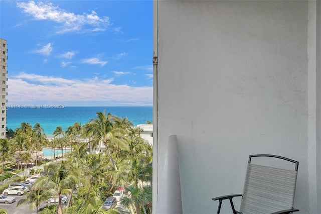 balcony with a water view and a beach view