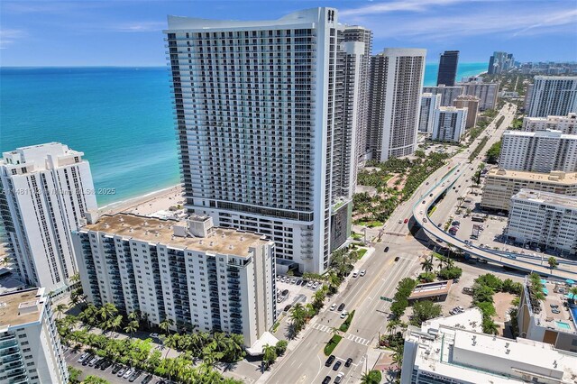 drone / aerial view featuring a view of the beach and a water view