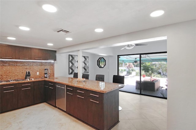 kitchen featuring backsplash, stainless steel appliances, light tile floors, and light stone counters