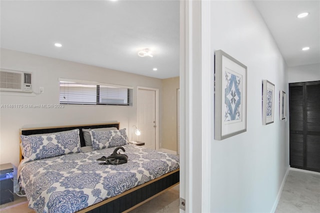 bedroom featuring a wall mounted air conditioner and light colored carpet