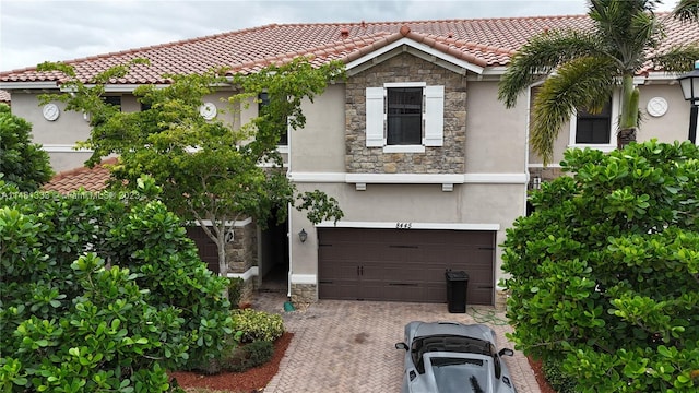 mediterranean / spanish-style house with a garage