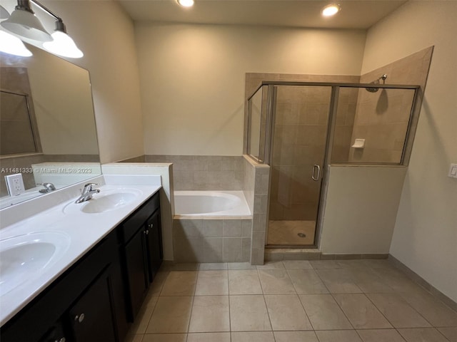 bathroom featuring vanity with extensive cabinet space, double sink, shower with separate bathtub, and tile flooring