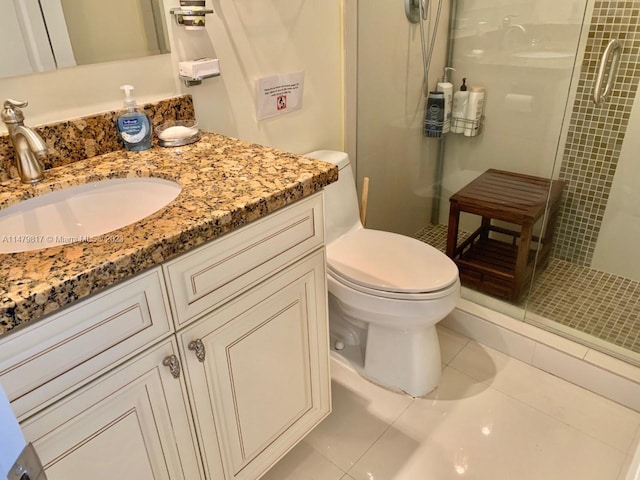 bathroom with walk in shower, tile floors, oversized vanity, and toilet