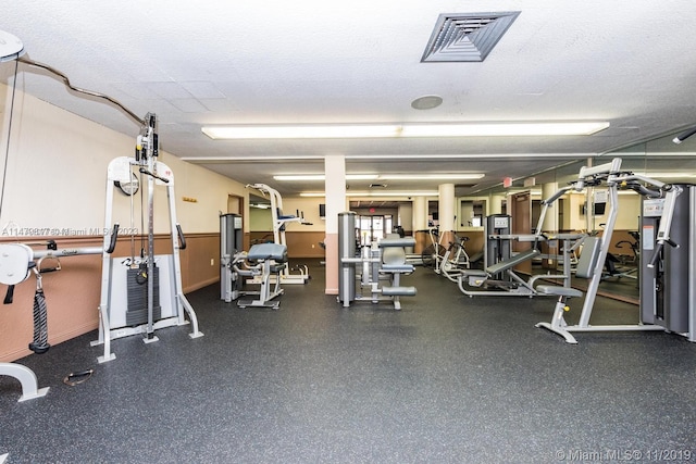 gym with a textured ceiling