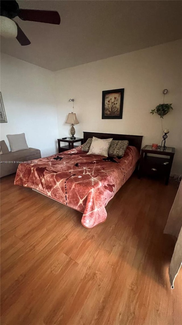 bedroom with hardwood / wood-style floors and ceiling fan