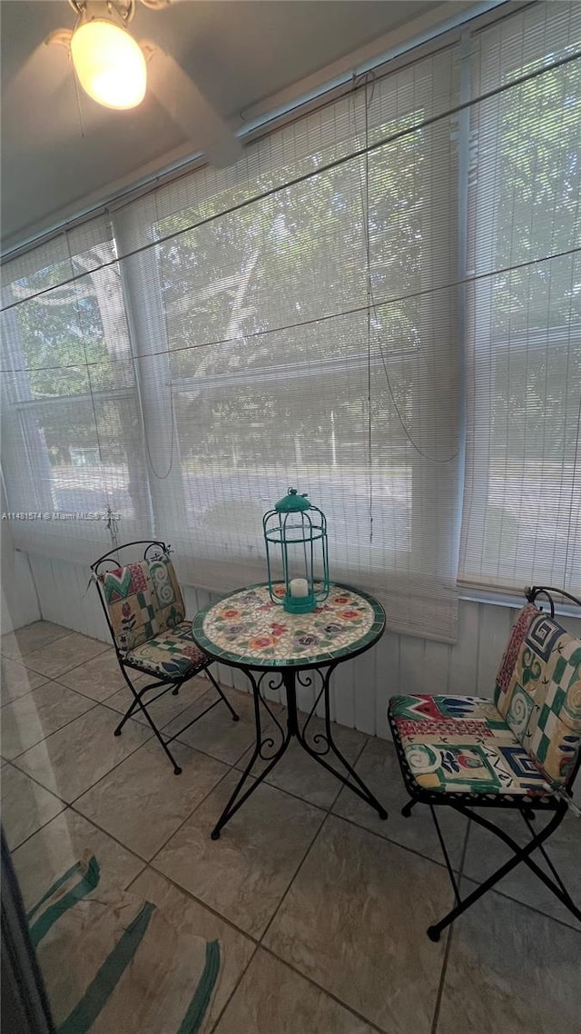 unfurnished sunroom featuring ceiling fan