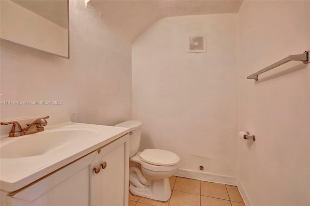 bathroom with toilet, tile floors, and vanity