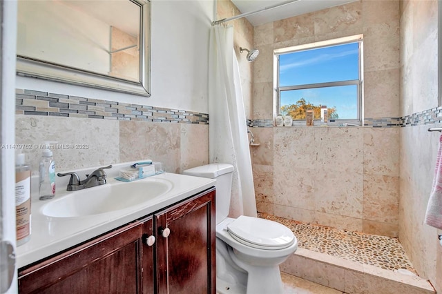 bathroom featuring tile walls, a shower with shower curtain, toilet, and vanity