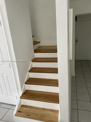 stairs with light tile floors