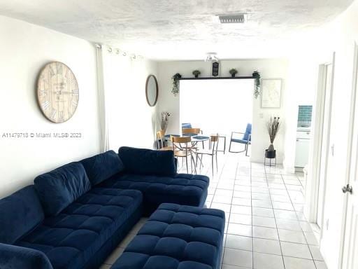 living room featuring light tile floors