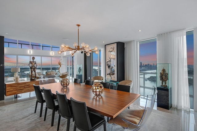 dining space with plenty of natural light, an inviting chandelier, and expansive windows