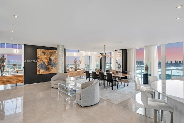 tiled living room with floor to ceiling windows and a chandelier