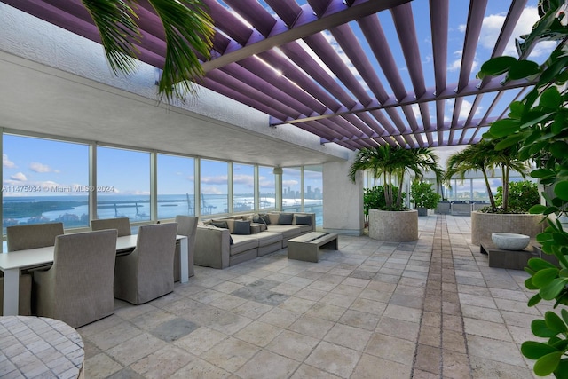 view of patio featuring a pergola, outdoor lounge area, and a water view