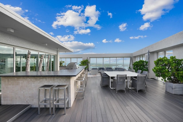 wooden terrace with a grill and a bar