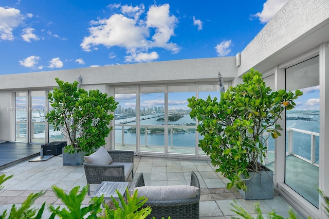 view of terrace featuring outdoor lounge area and a water view