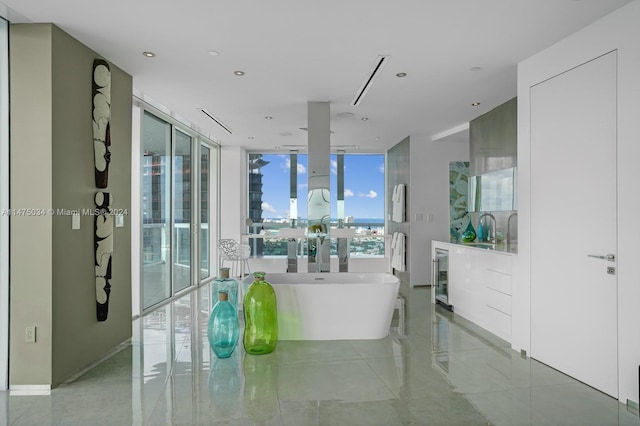 interior space featuring floor to ceiling windows, wine cooler, tile flooring, a washtub, and sink